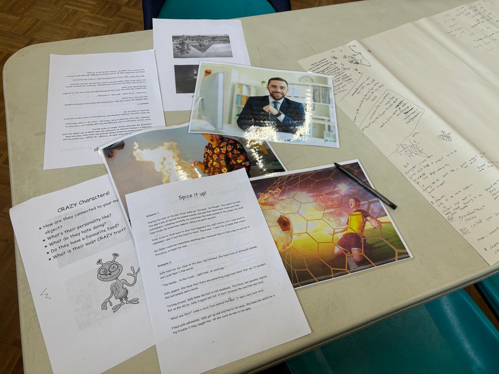 Creative-writing prompts and worksheets laid out on a class table