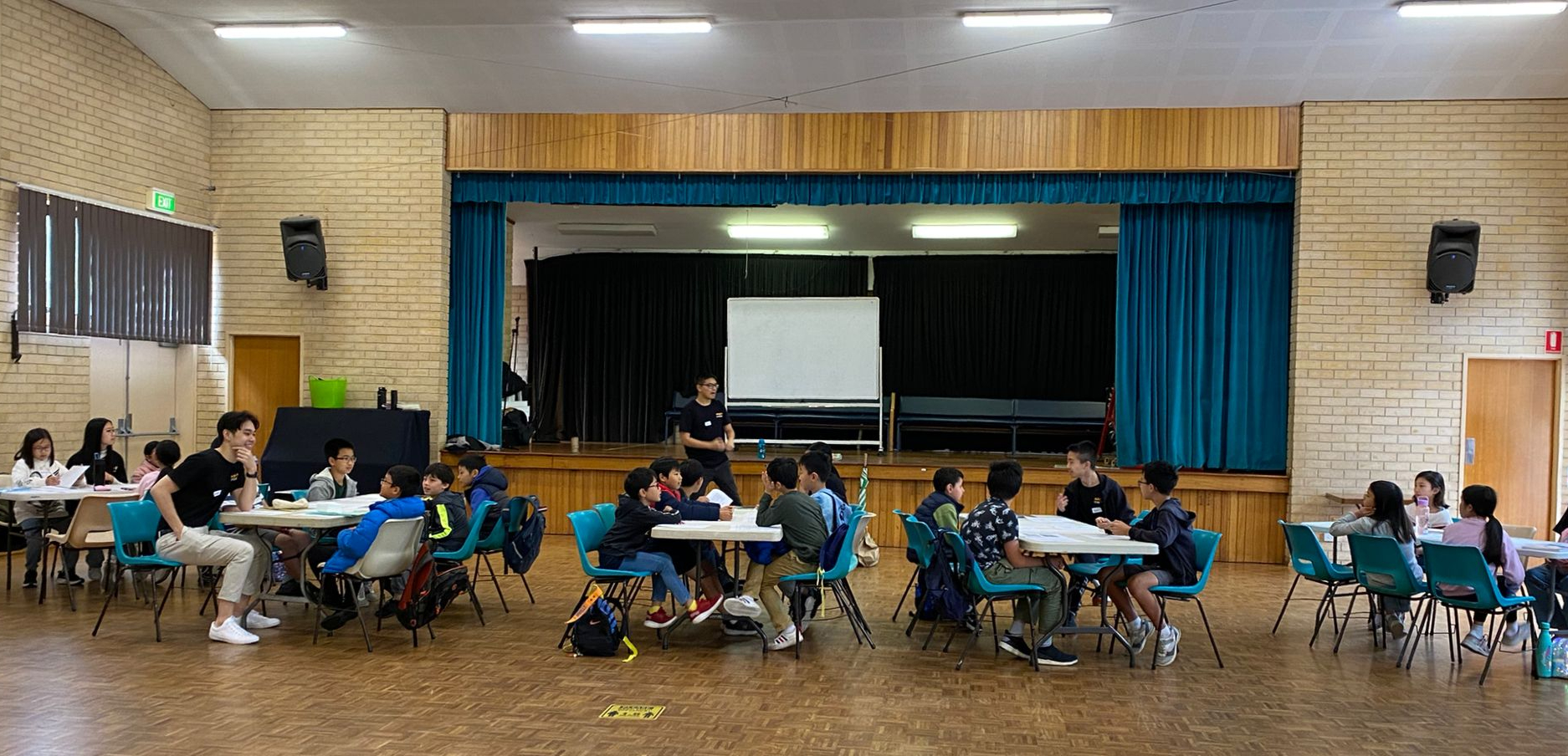 An Alight Creative class in session at the church hall — students writing together at tables